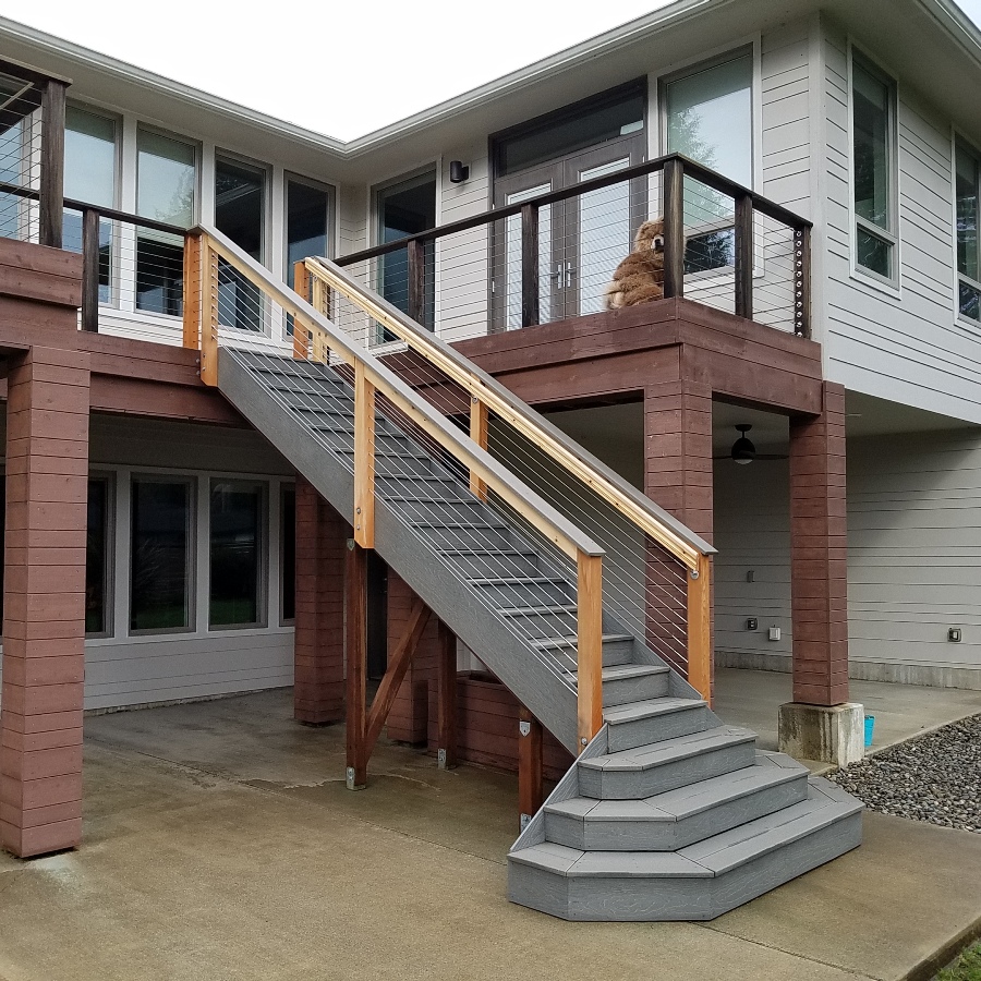 Composite deck with staircase and cable railing