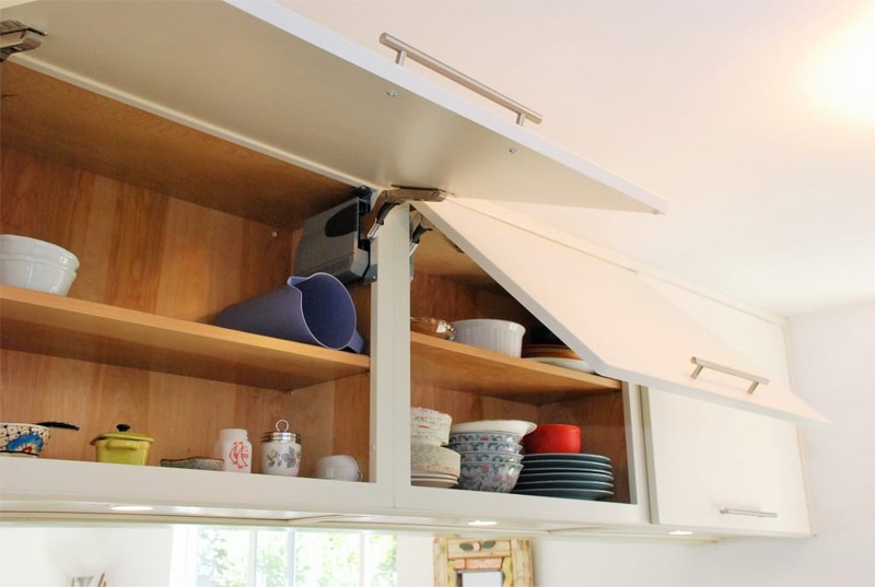 European cabinets above refrigerator, with closers